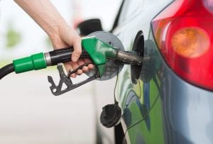 person using petrol pump to fill car