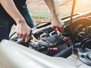 car battery being changed by man