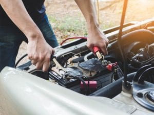 man changing car battery uk