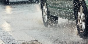 grey car driving in the rain 