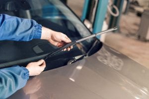man changing windscreen wiper