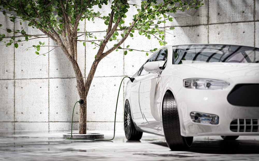 Charging an electric car with green energy - concept. Electric e Electric Zero Emission Cars