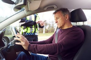 Man in car being stopped by police uk