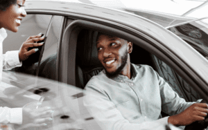 man test driving car at dealership